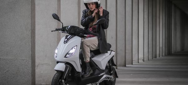 lady putting on helmet on italian scooter