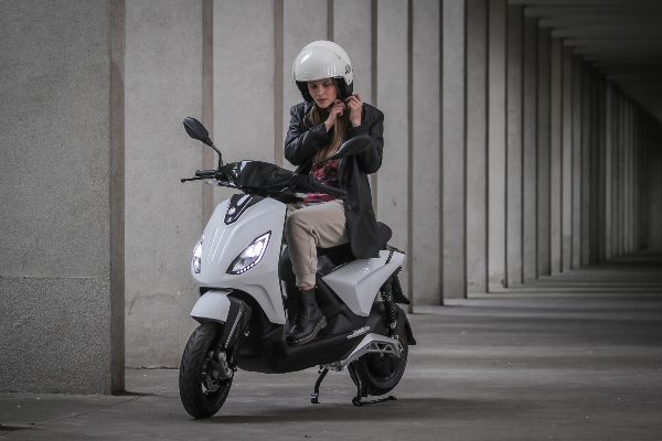 lady putting on helmet on italian scooter
