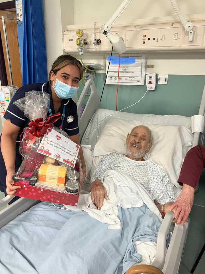 Patient being presented with a Christmas Hamper