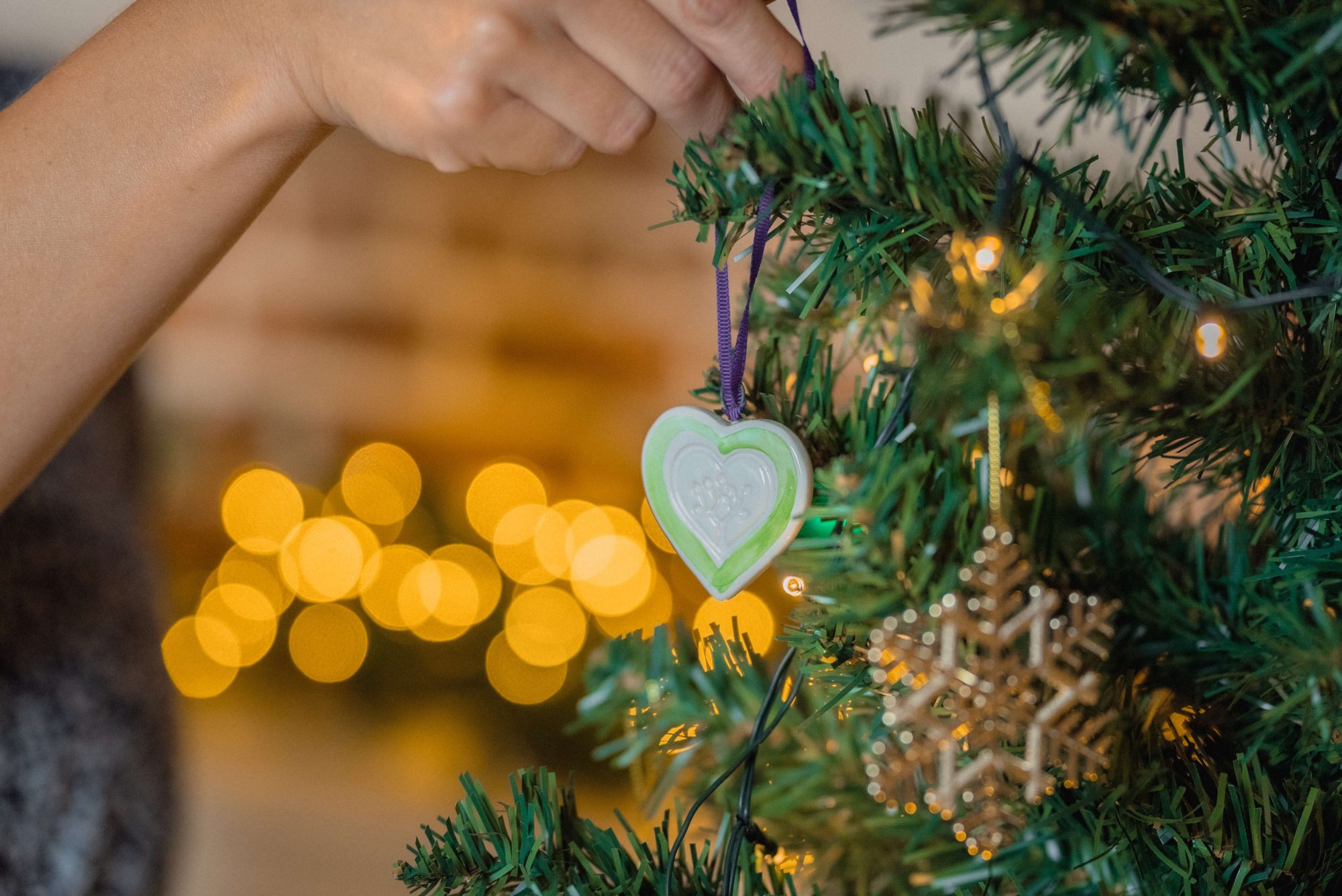 Ceramic heart hanging on pine tree