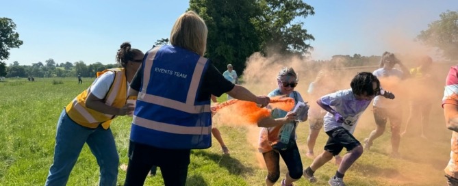 A volunteer helps at the Colour Run