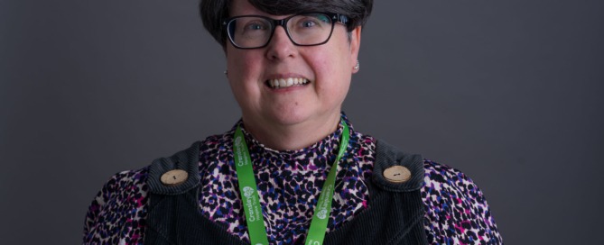 Picture of a dark haired woman with glasses